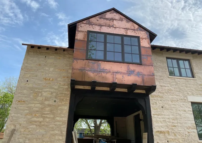 Copper metal panel facade on a stone building for Skylight Installation in Redding